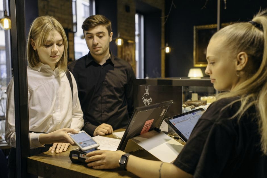 Customer paying with a smartphone at a point-of-sale terminal